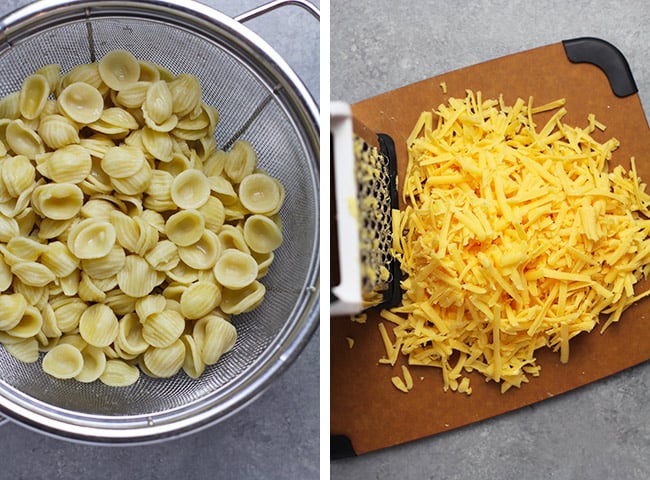 Collage of 1) some orecchiette pasta in a colander and 2) some freshly grated cheddar cheese on a board.