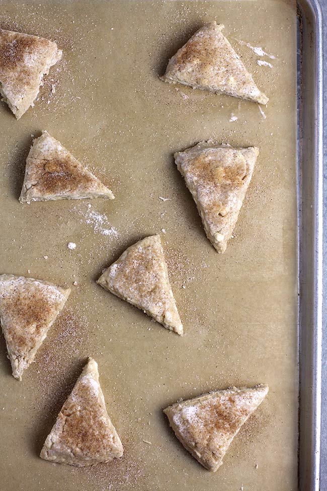 The scone triangles before baking, on a baking sheet.