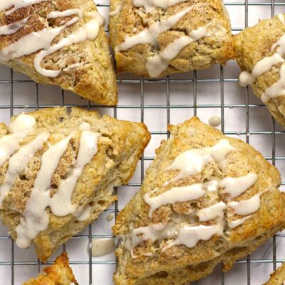 Several snickerdoodle scones on a cooling rack.