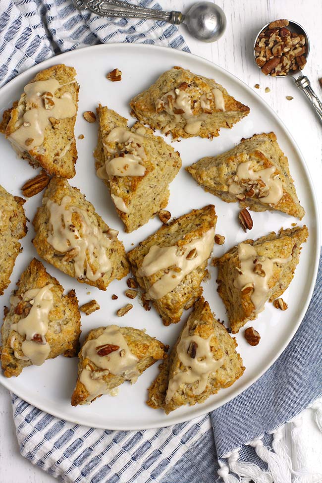 A large plate full of maple nut scones with maple icing.