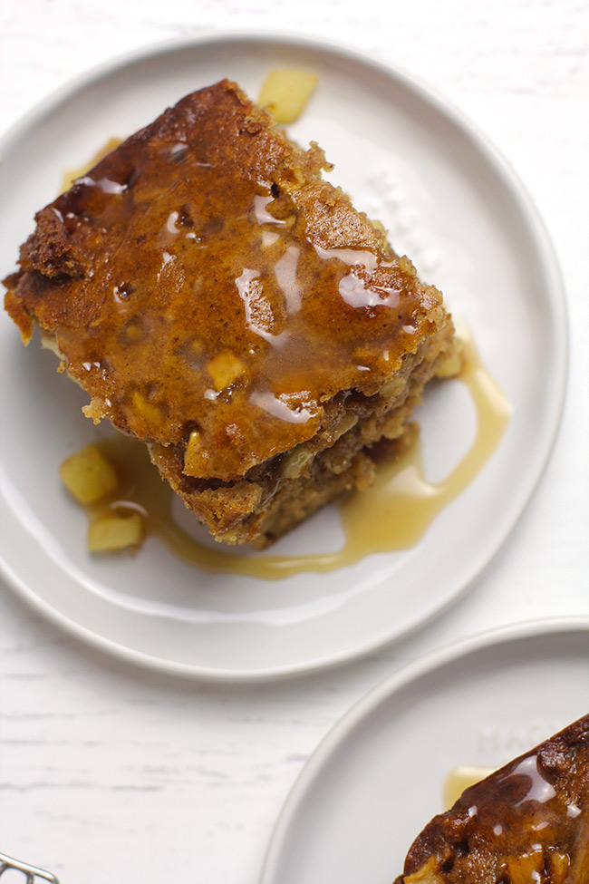 Overhead shot of two servings of apple cake, with caramel sauce on top.