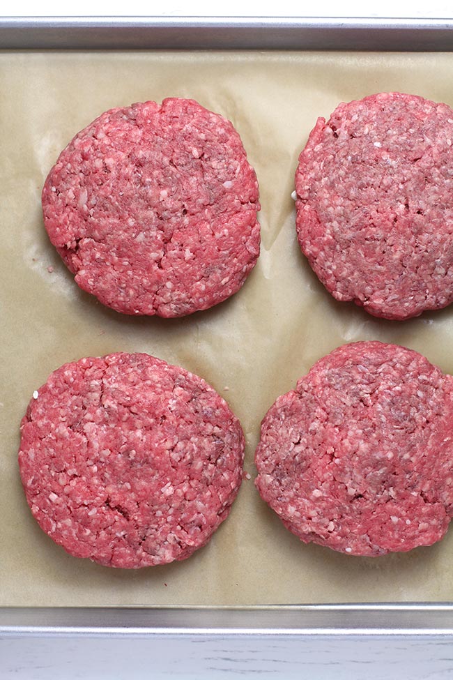 A baking sheet showing the ready to grill patties.