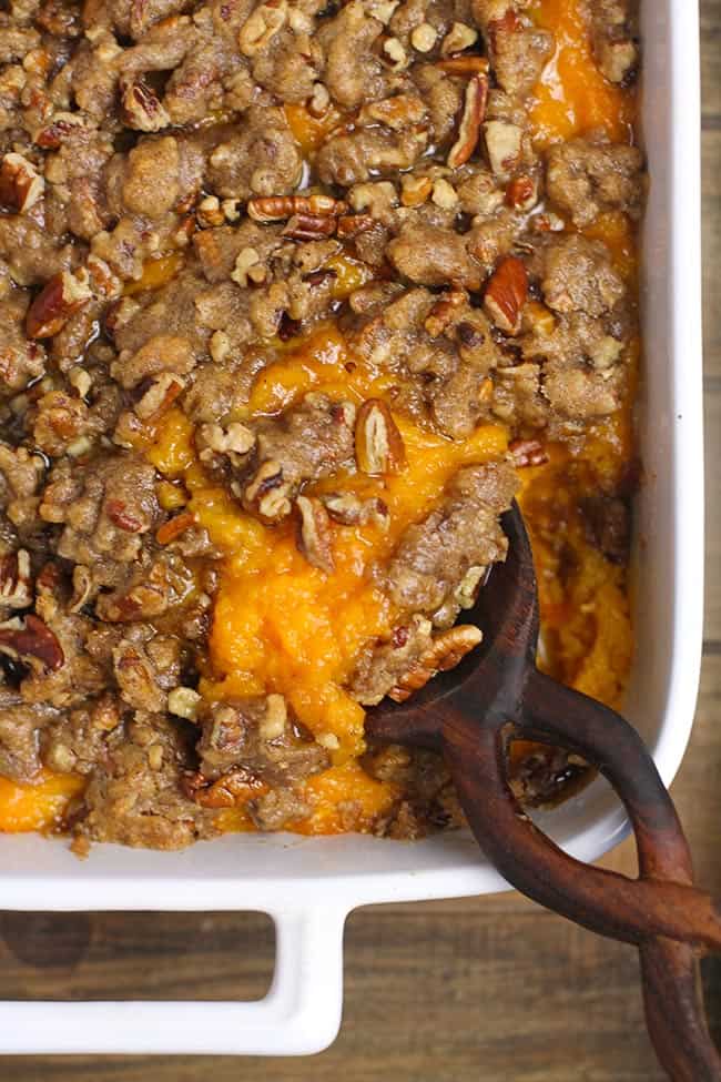 Closeup of sweet potato casserole with pecan crumble topping.