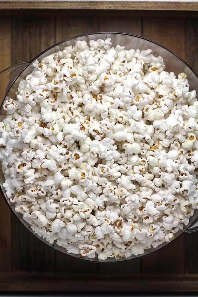 A large bowl of popcorn in stir crazy lid.