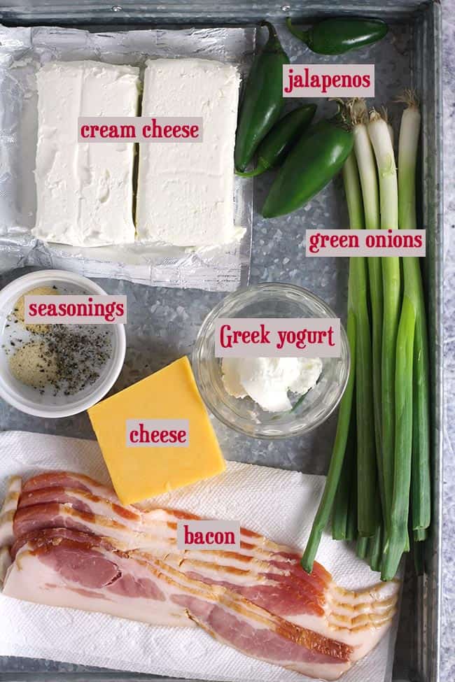 A gray tray with all the ingredients for the cheese ball.