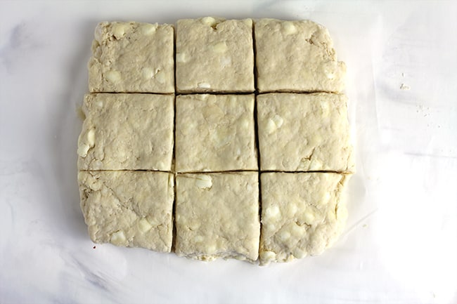 The biscuit dough cut into nine squares.