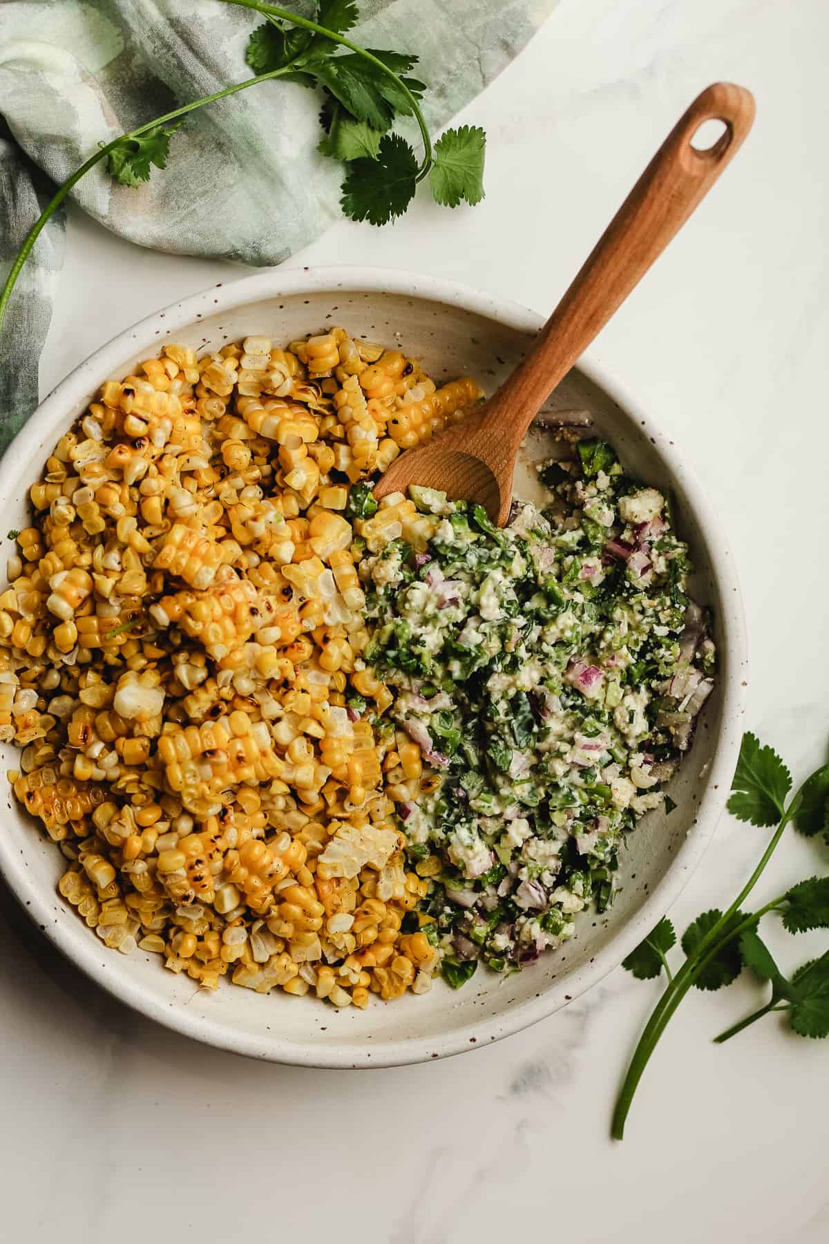 A bowl of the grilled corn and the salad ingredients.
