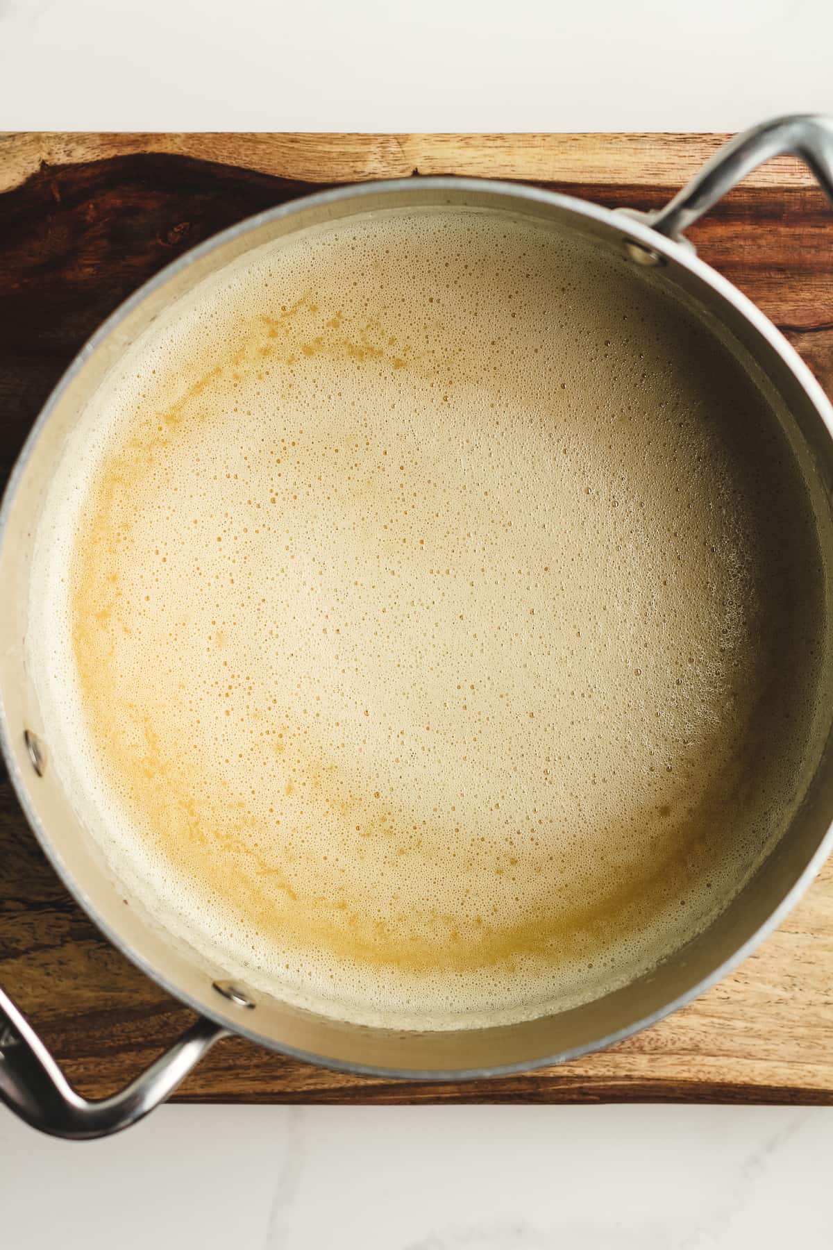 A pan of the browned butter with the tempered eggs.