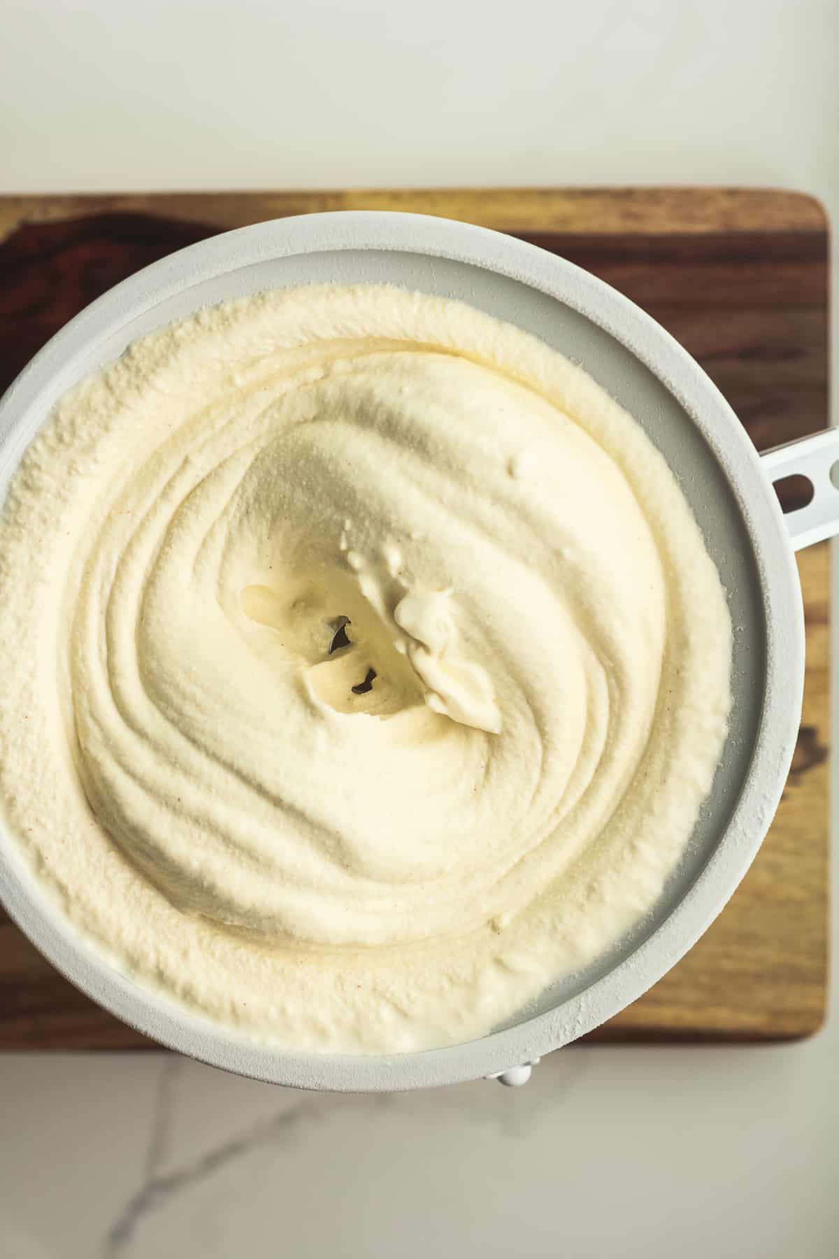 An ice cream maker with the finished butter pecan ice cream.