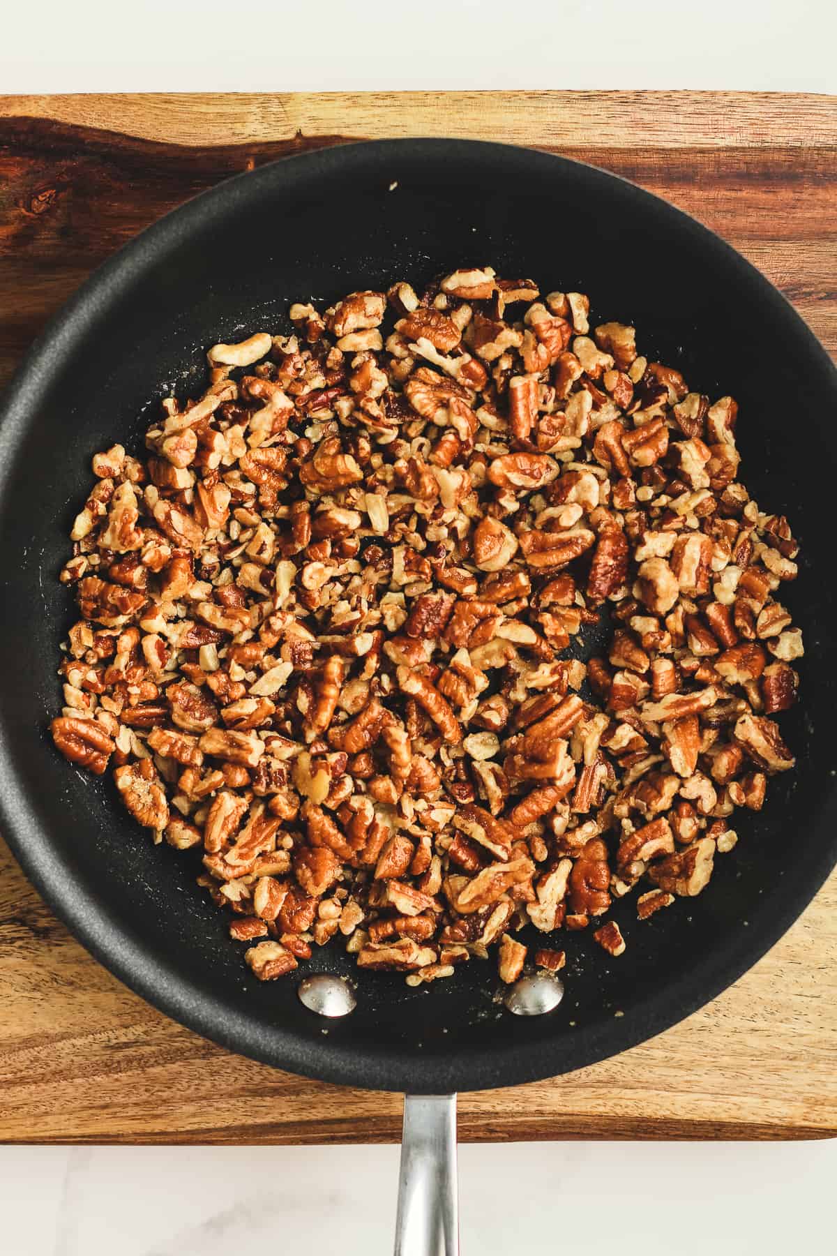 A skillet of chopped pecans.