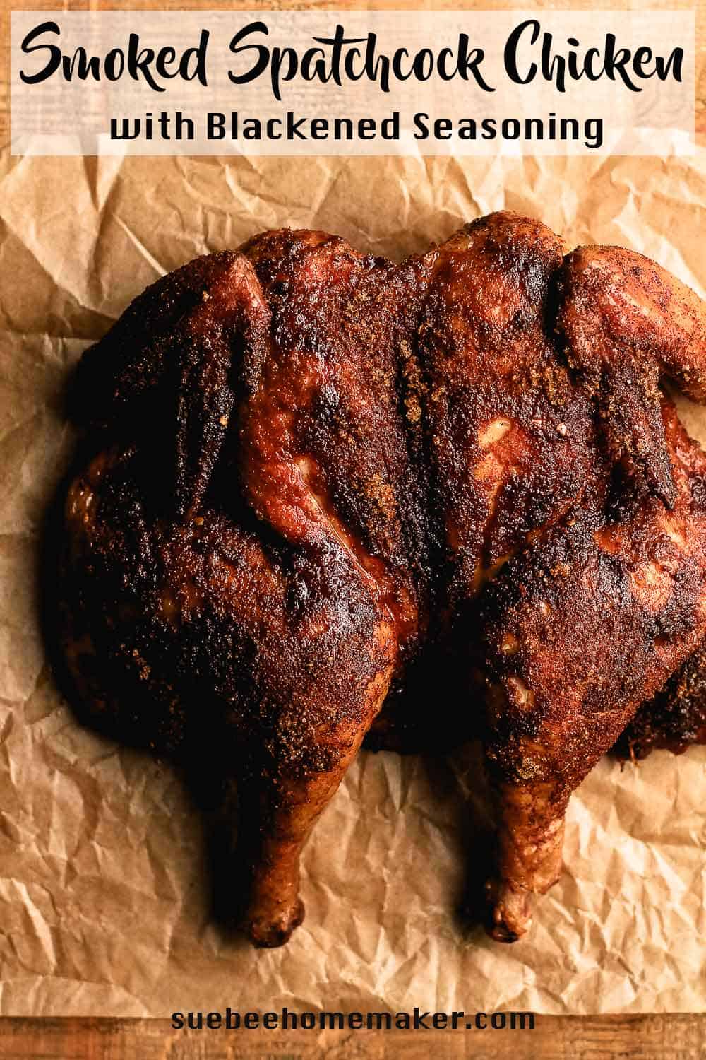 Overhead view of a smoked spatchcock chicken on parchment paper.