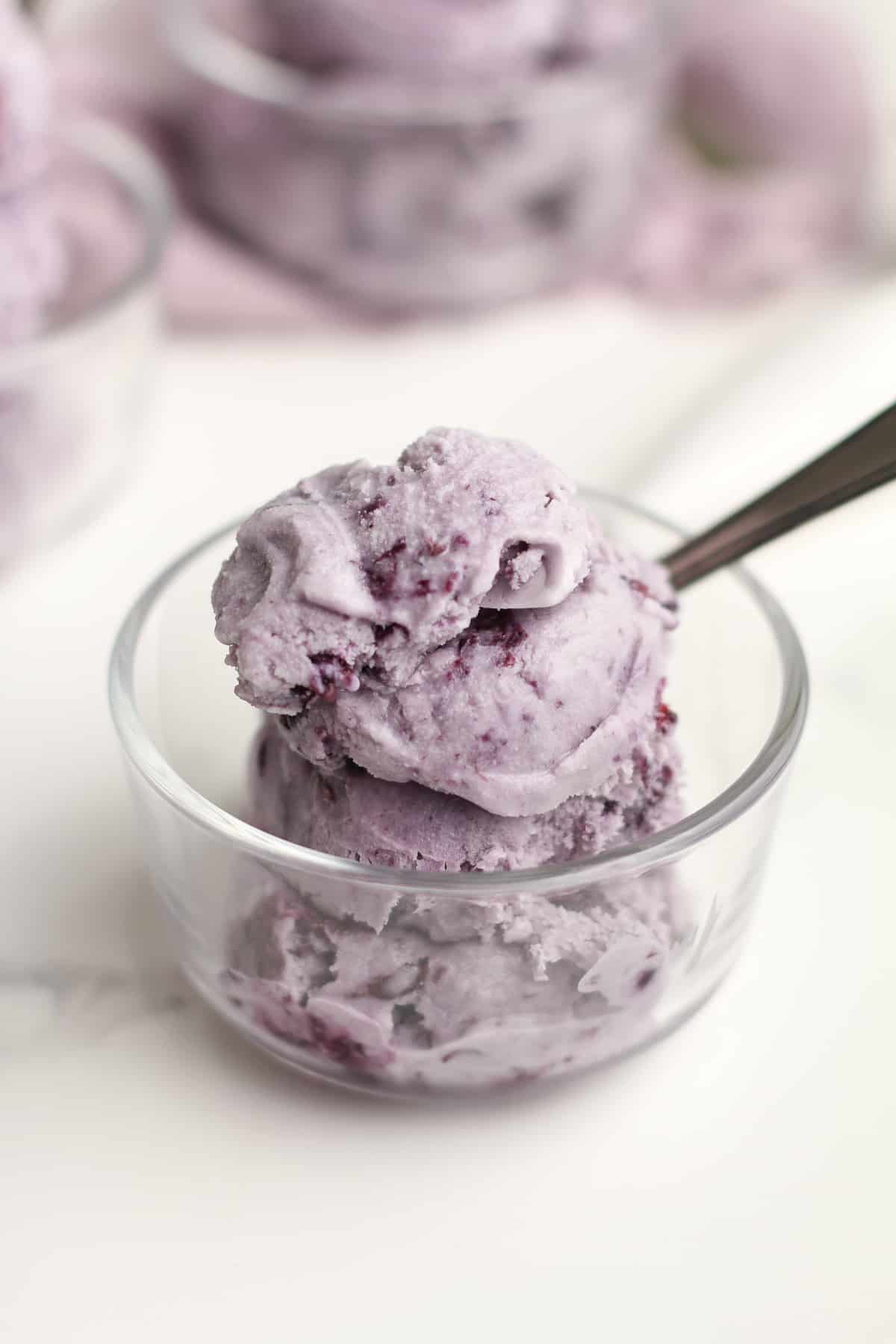 Side shot of one bowl of blueberry ice cream.