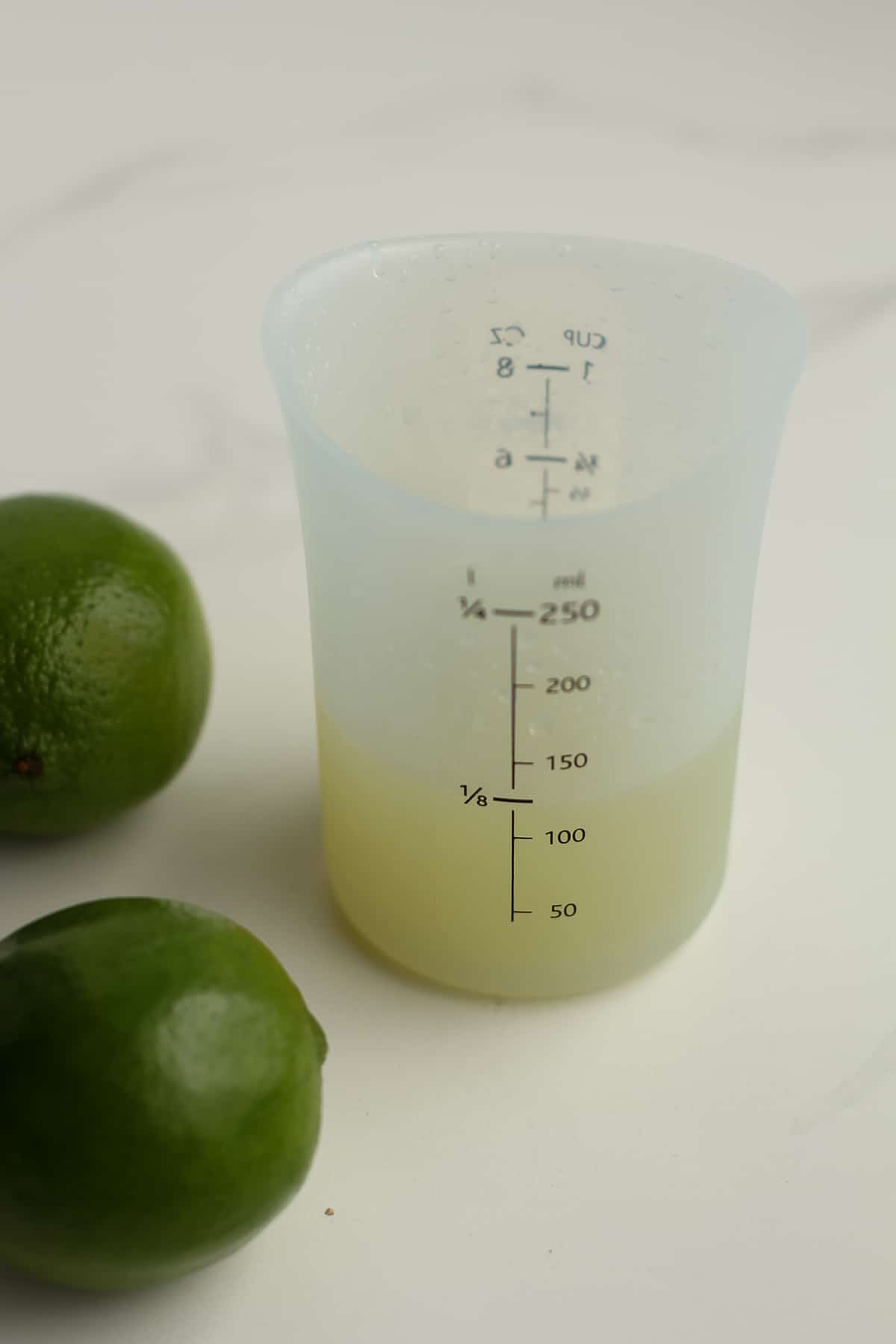 Side shot of freshly squeezed lime juice.