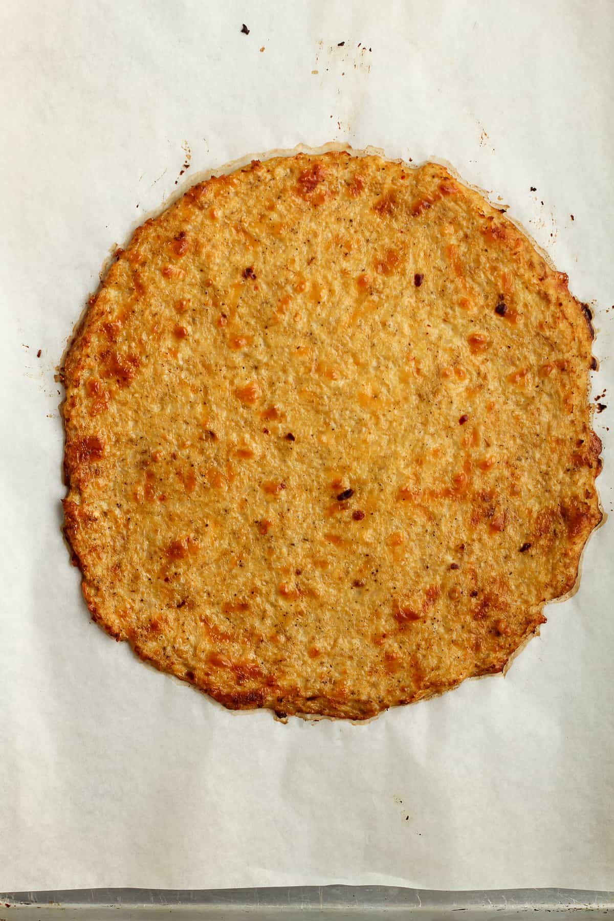 A pan of baked cauliflower crust.