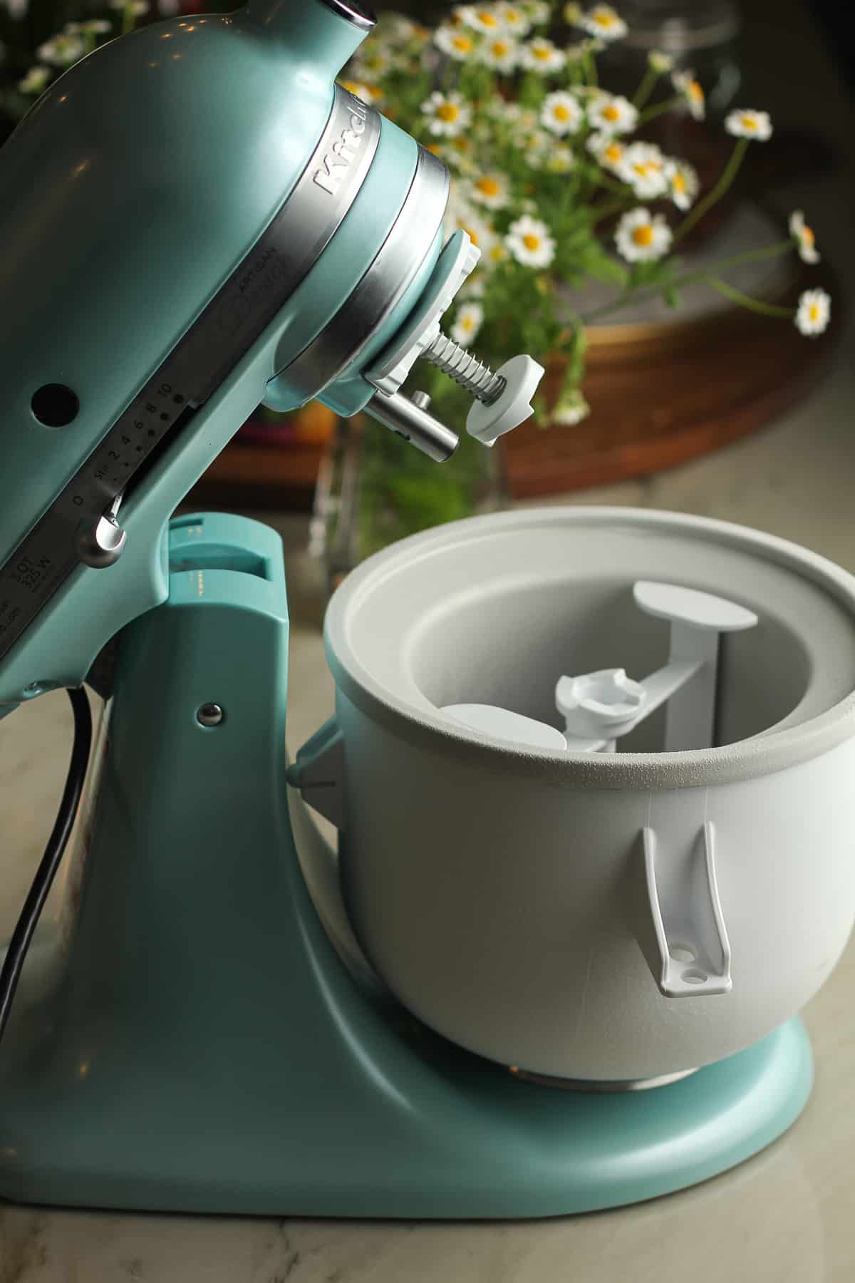 Side shot of a KitchenAid mixer with an ice cream attachment.