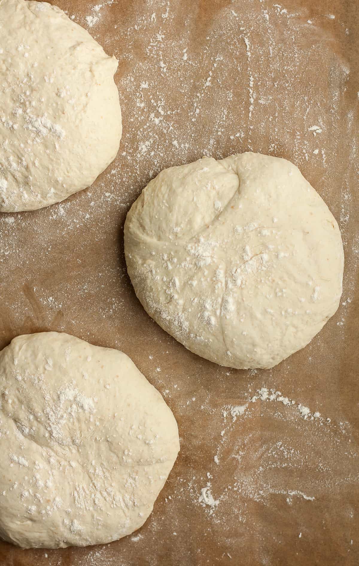 Overhead shot of three rounds of sourdough pizza rounds.