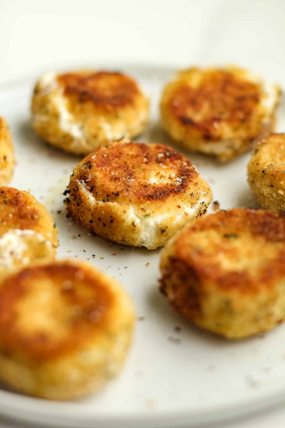 Side view of a plate of fried goat cheese.