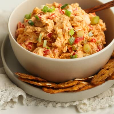 A bowl of southern pimento cheese, with pretzel crisps.