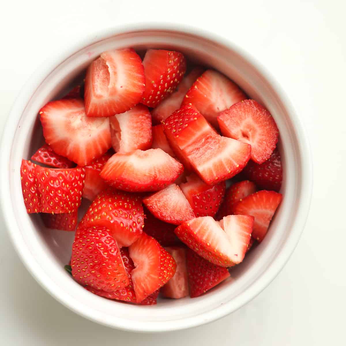 A bowl of sliced strawberries.