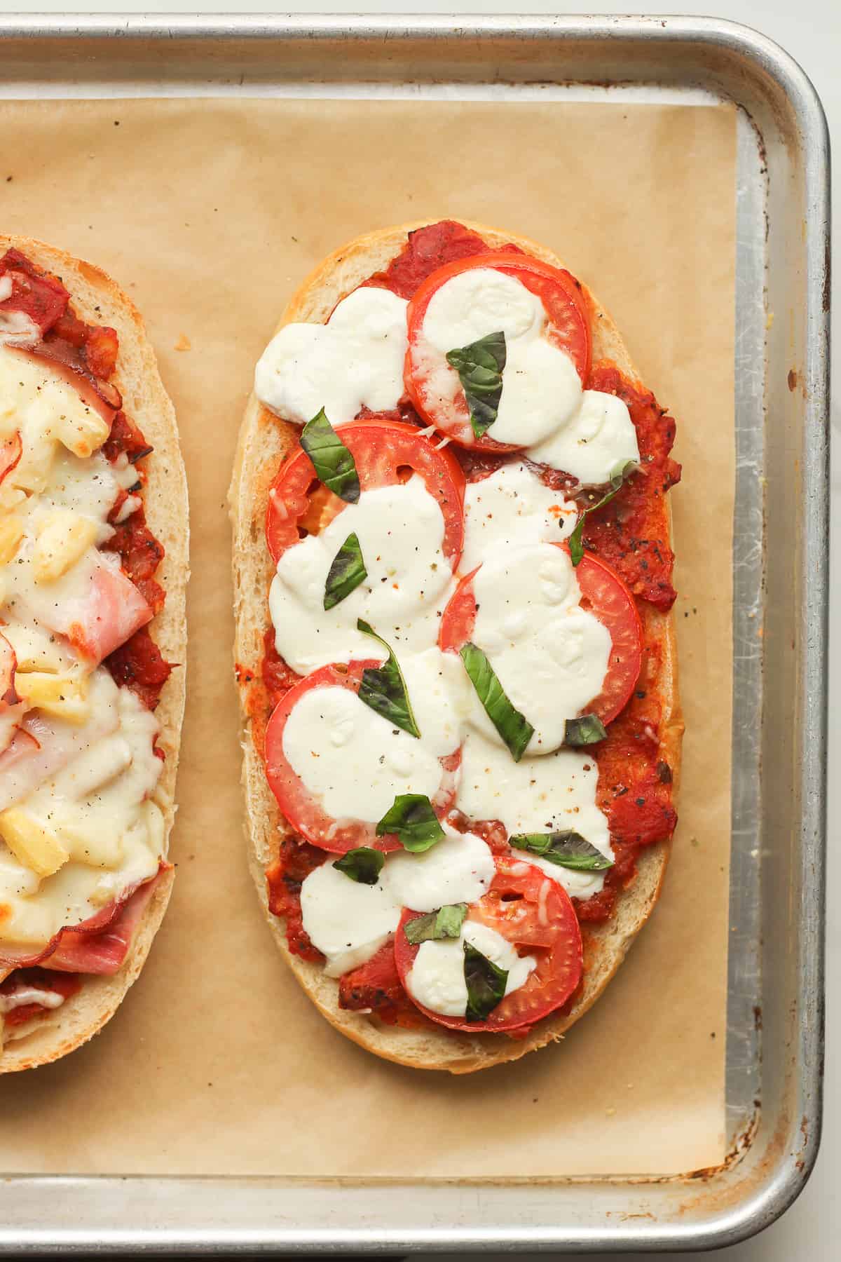 A just baked caprese salad French bread pizza.