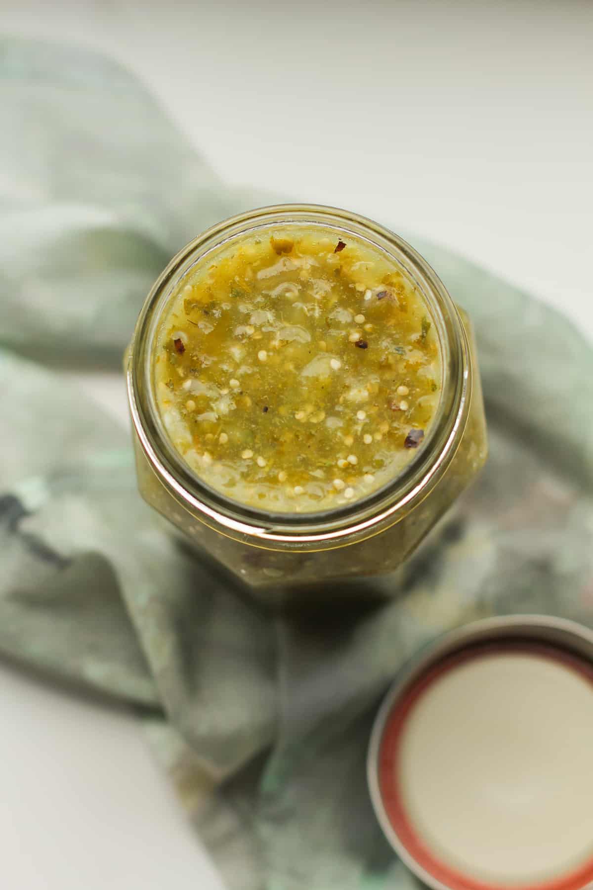 Overhead shot of a jar of homemade salsa verde.