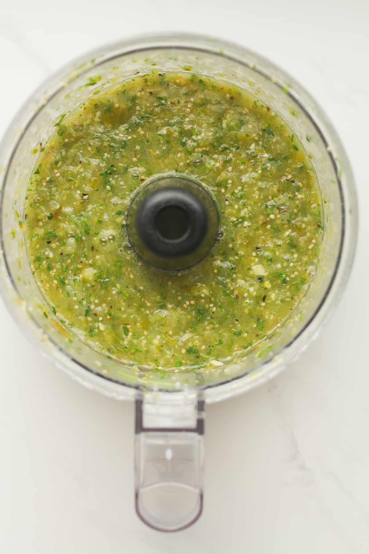A food processor of salsa verde.
