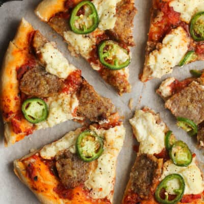 Overhead shot of meatball pizza with jalapeños.