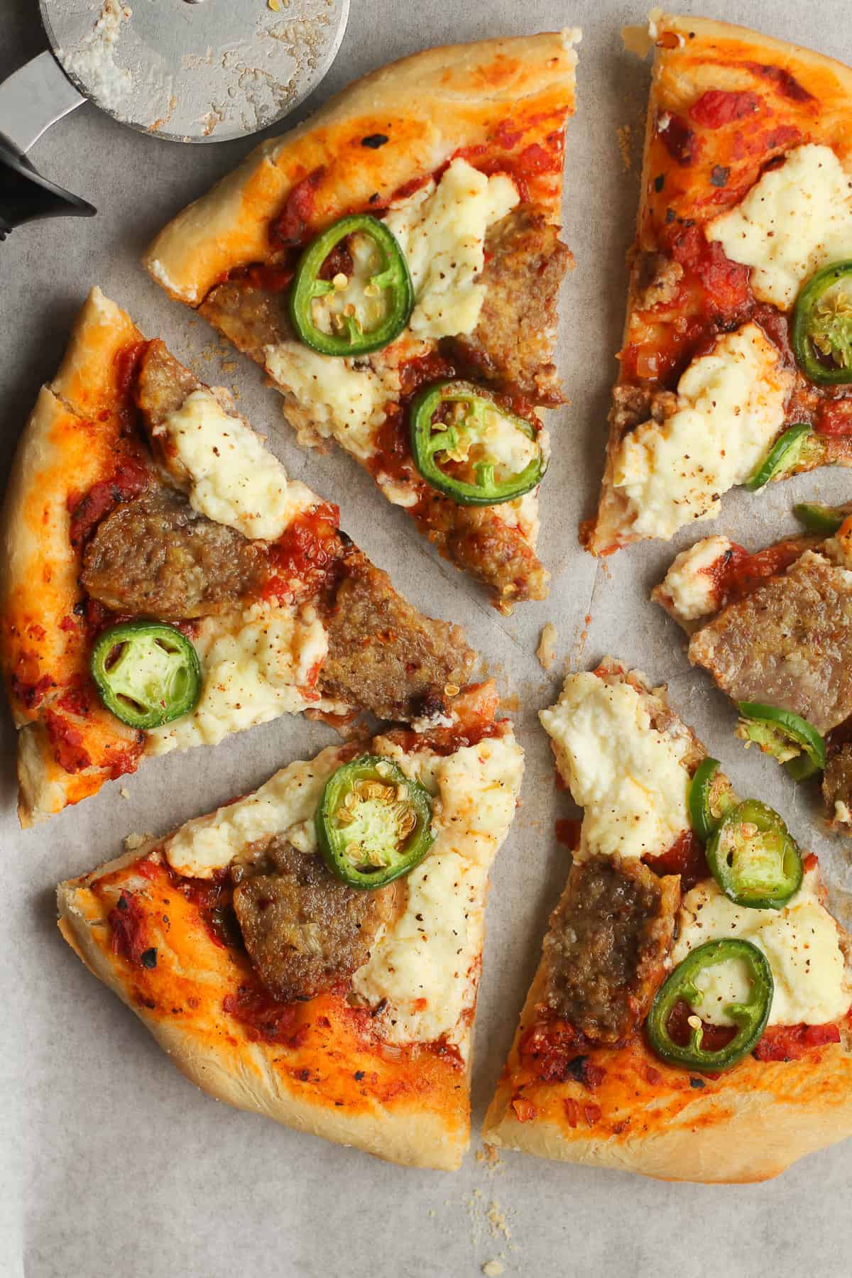 Overhead shot of meatball pizza with jalapeños.