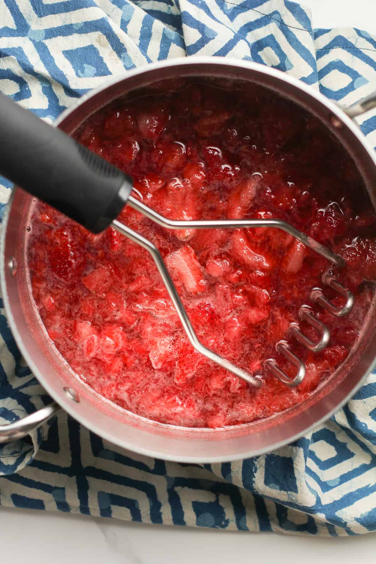 A pan of cooked strawberries for cocktails.