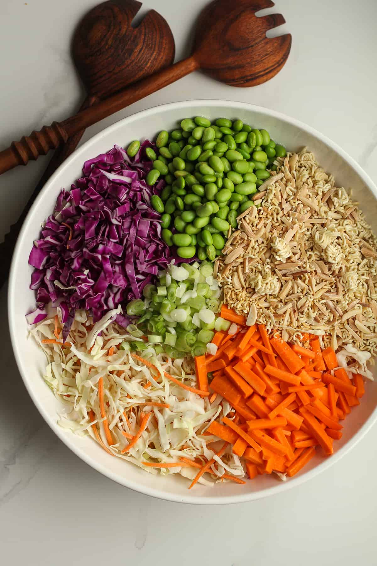 A bowl of the salad divided by ingredient.