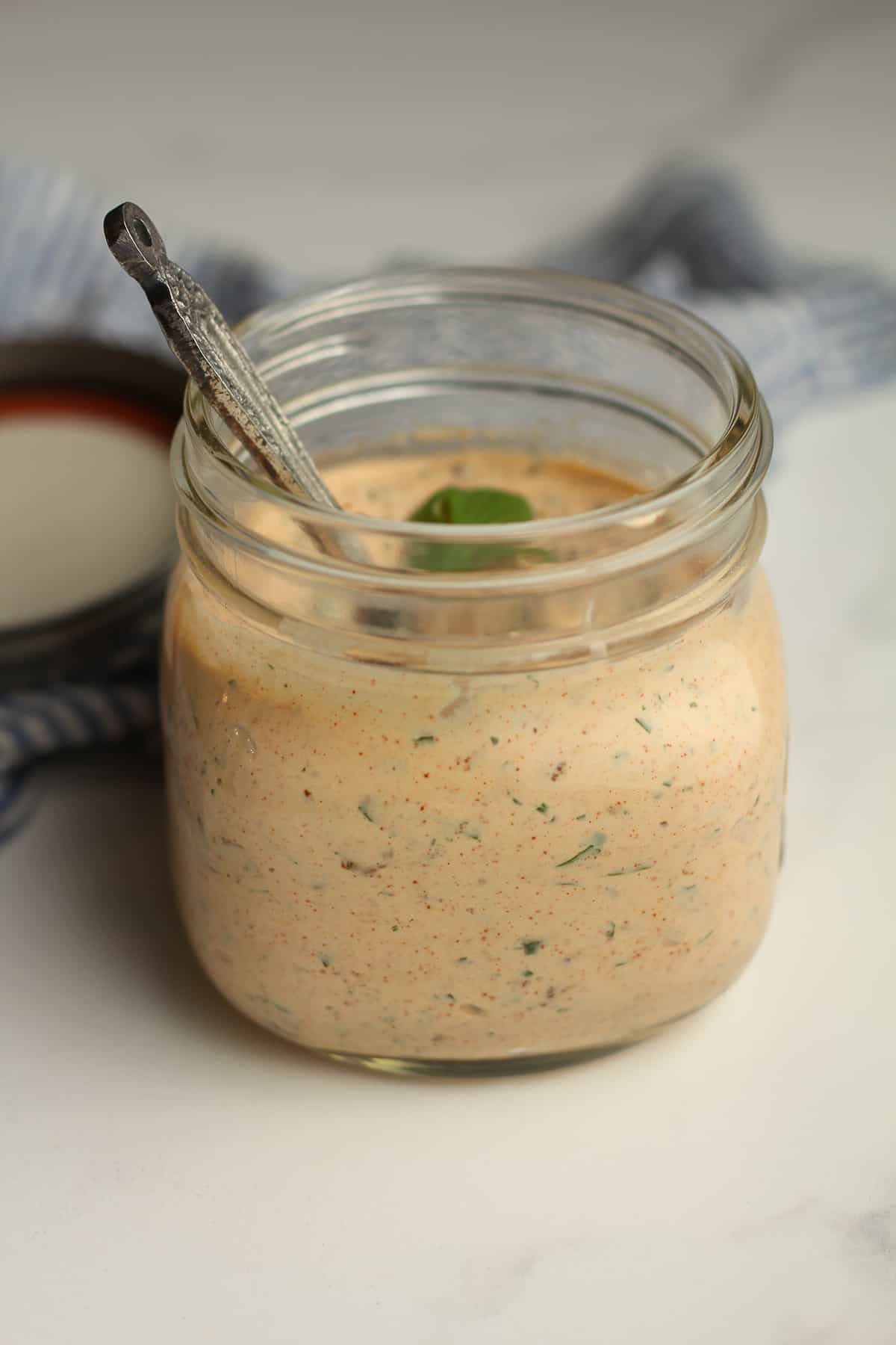 Side shot of a jar of dressing.