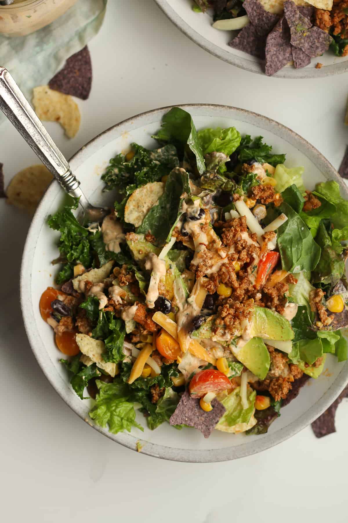 A tossed taco salad with dressing mixed in.