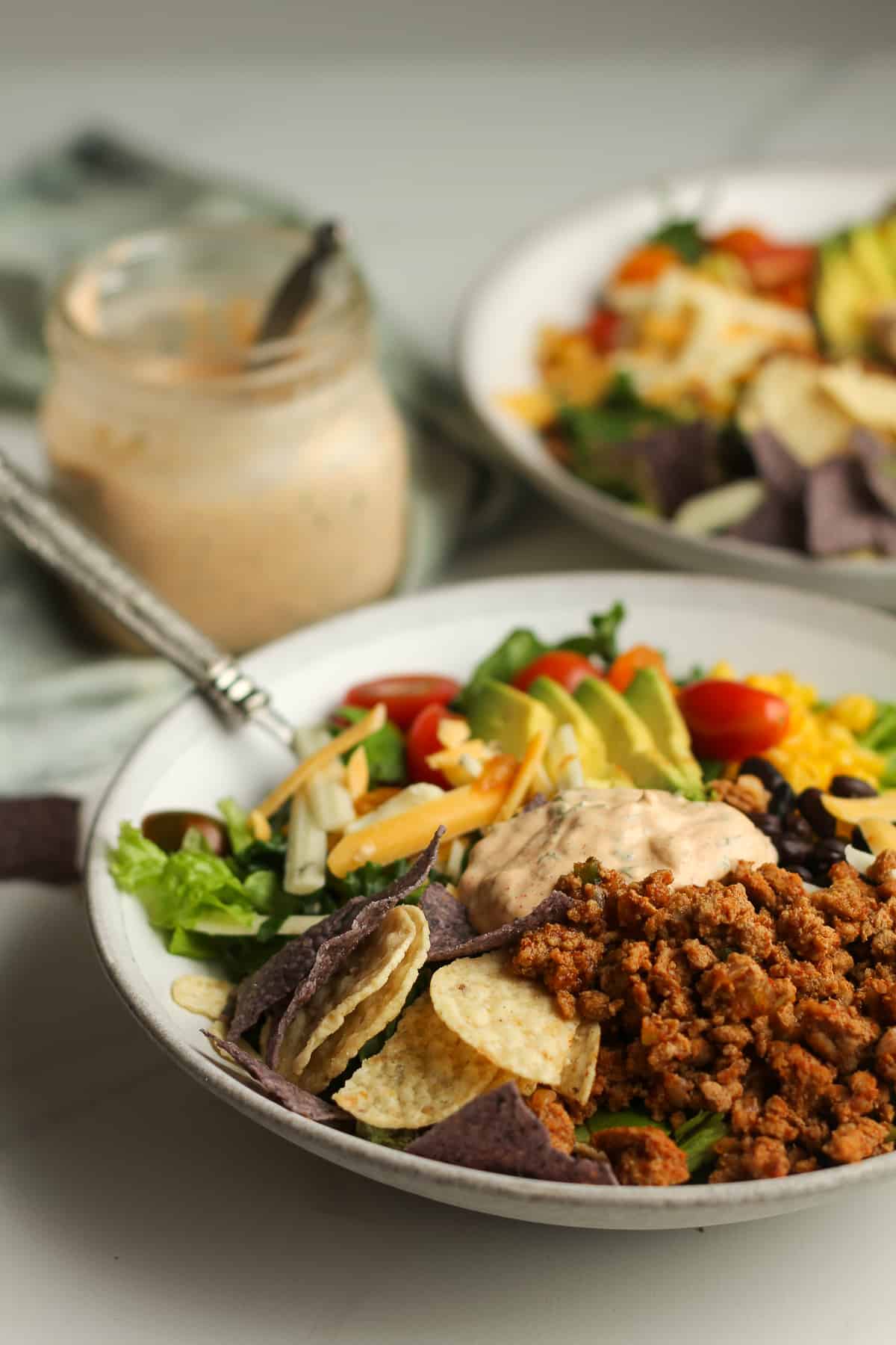 Side shot of two bowls of taco salad.