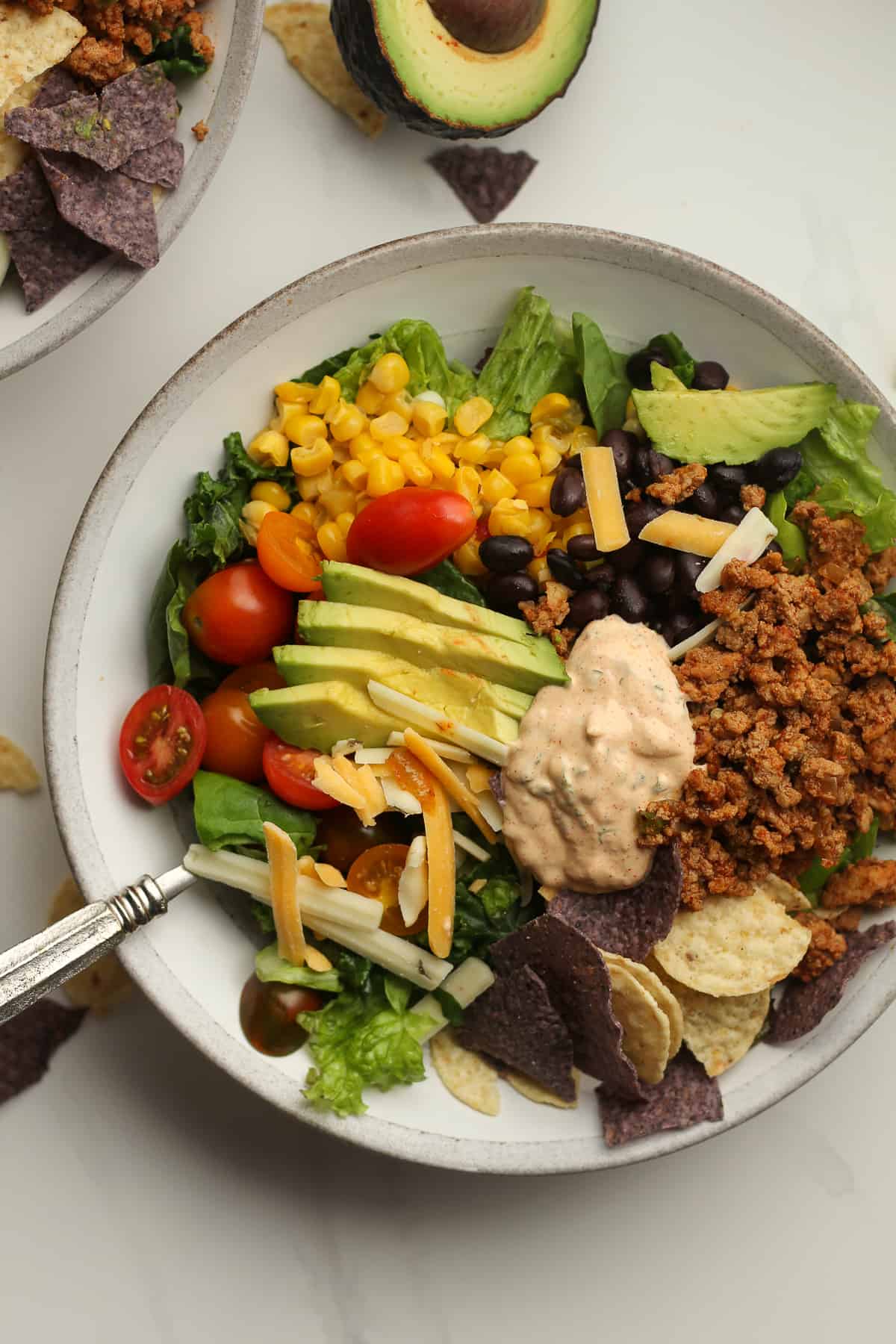 Closeup on a bowl of healthy taco salad recipe with chipotle ranch dressing.