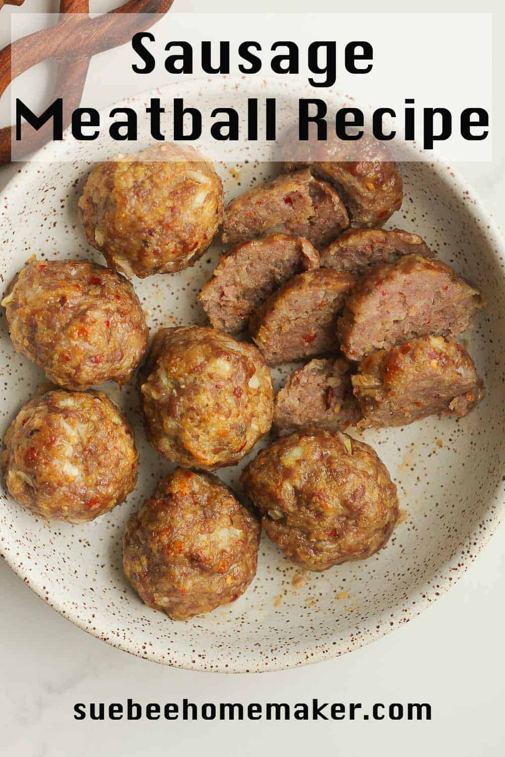 A bowl of sausage meatballs, with some sliced.