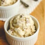 Side shot of two bowls of butter pecan ice cream.
