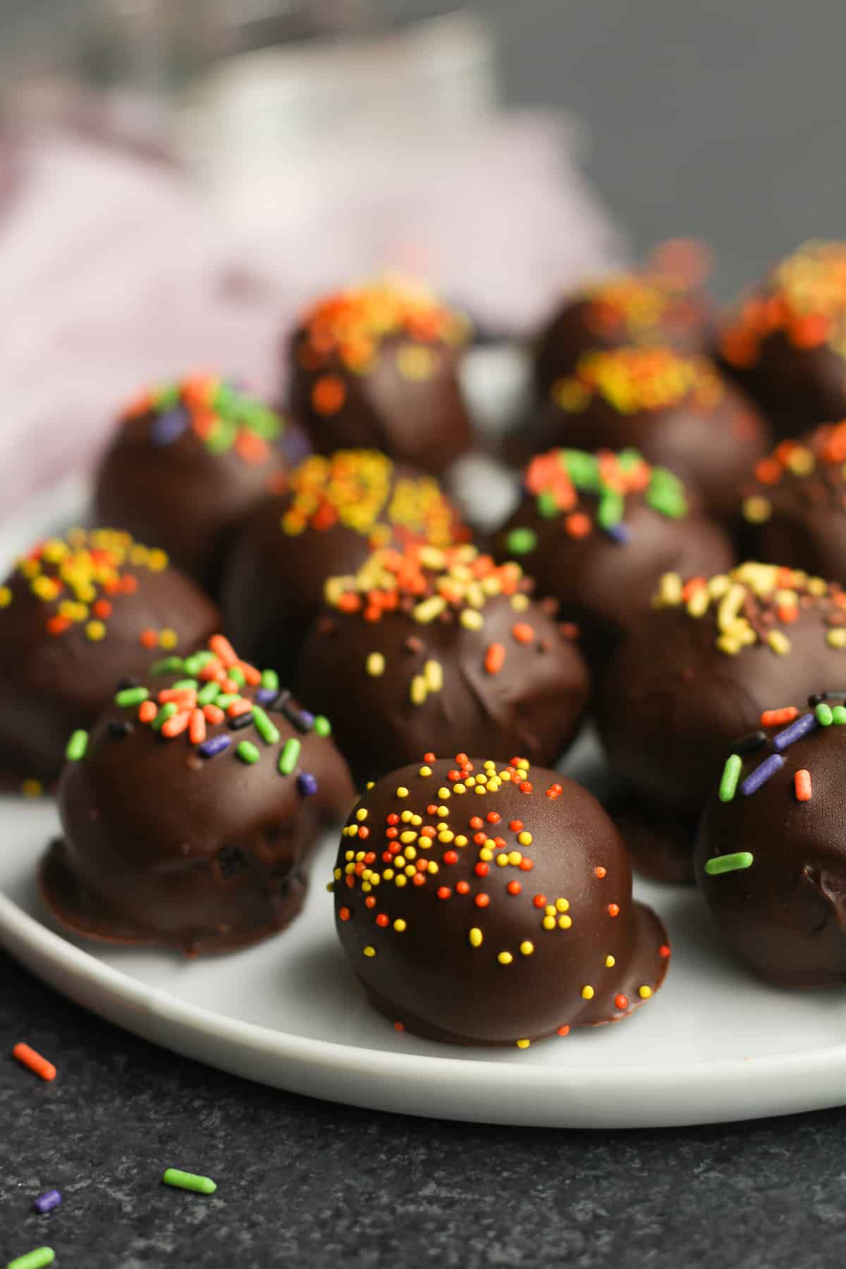 Side shot of a plate of Halloween Oreo balls.
