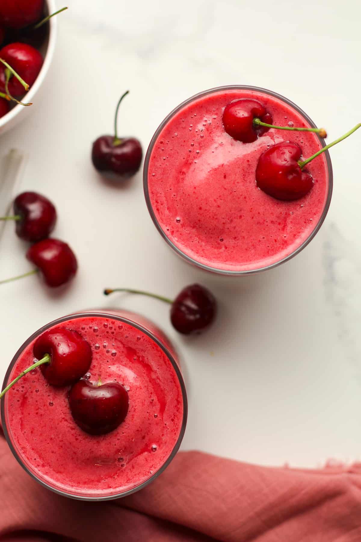 Overhead shot of two cherry smoothies.