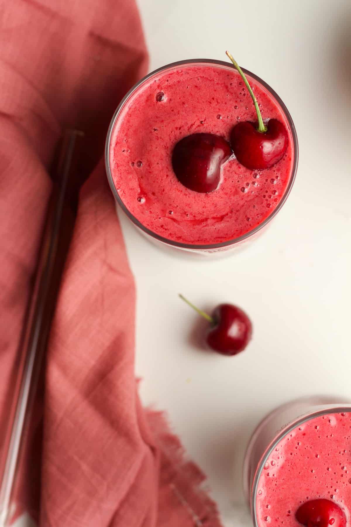 Overhead shot of two cherry smoothies.