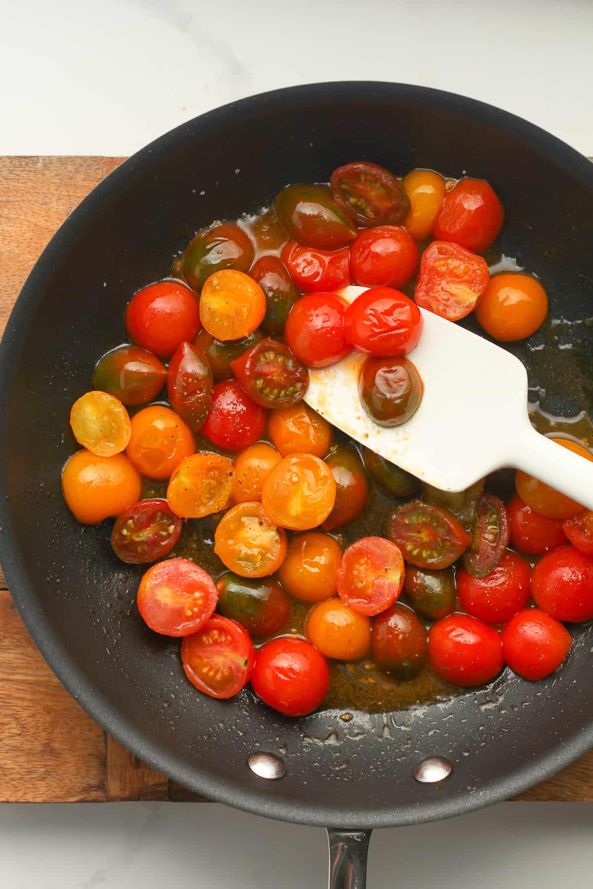 A skillet of sautéed tomatoes.
