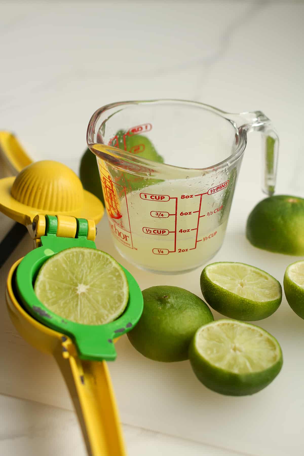 A measuring glass of fresh lime juice.