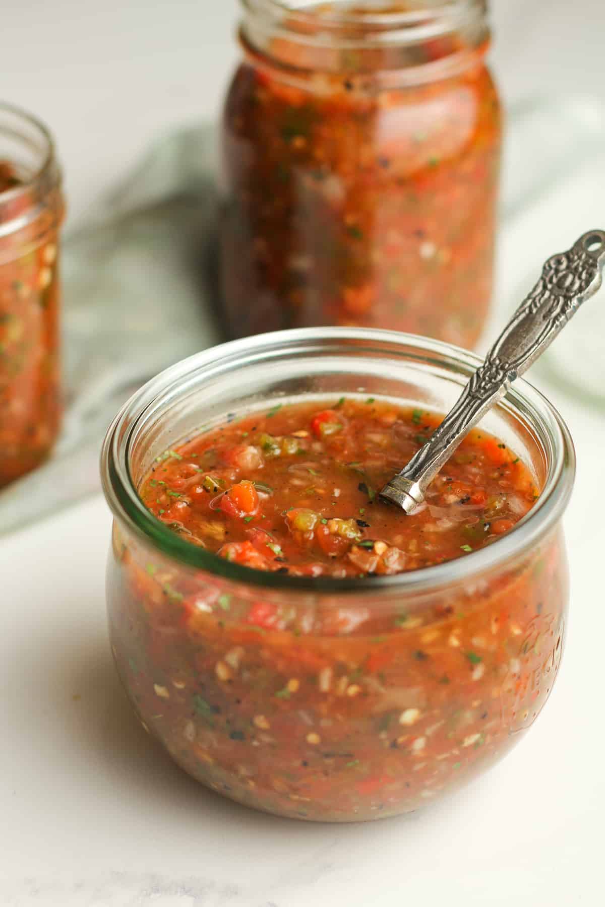 Side shot of some grilled salsa with a spoon.