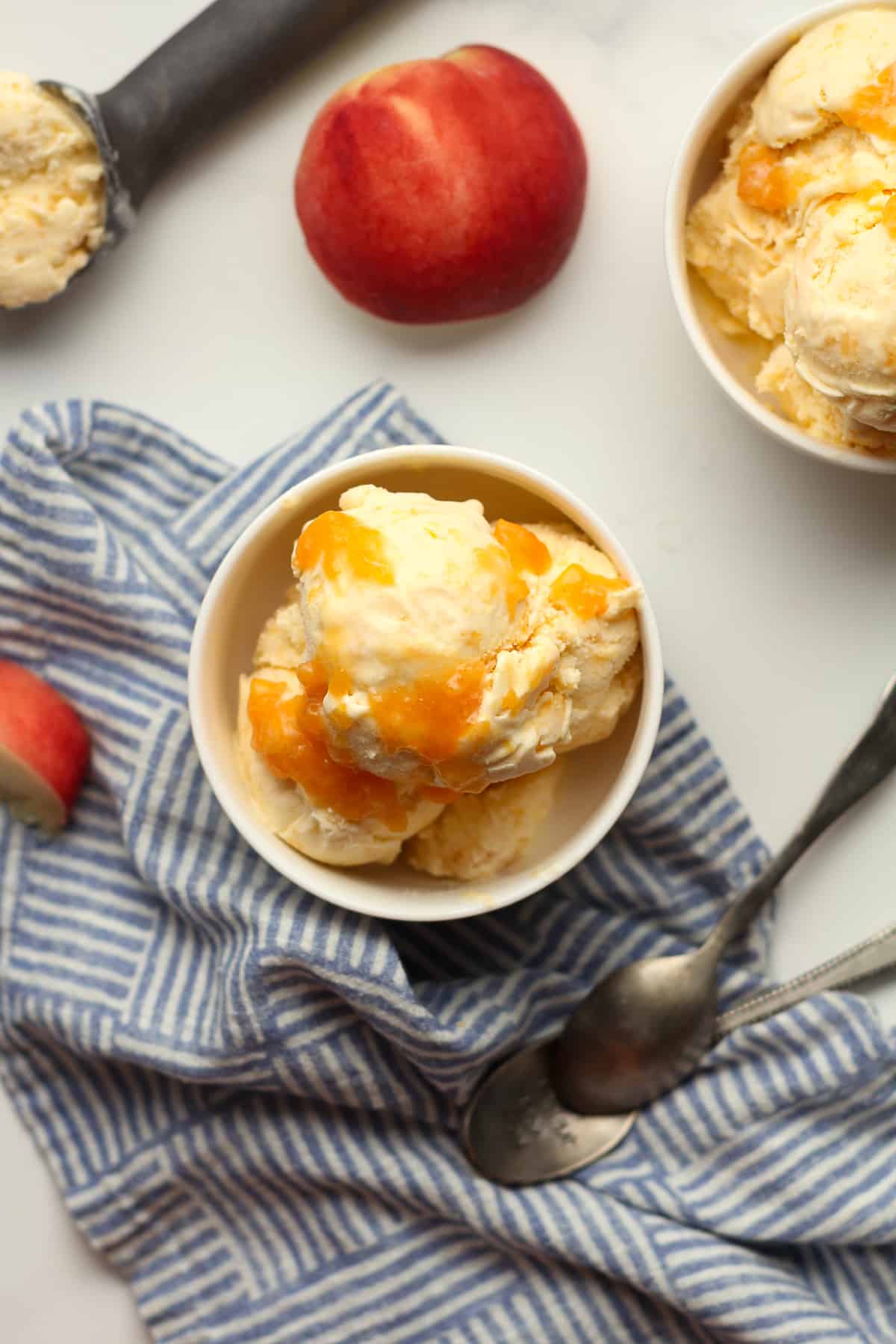 Overhead shot of two bowls of peach ice cream.