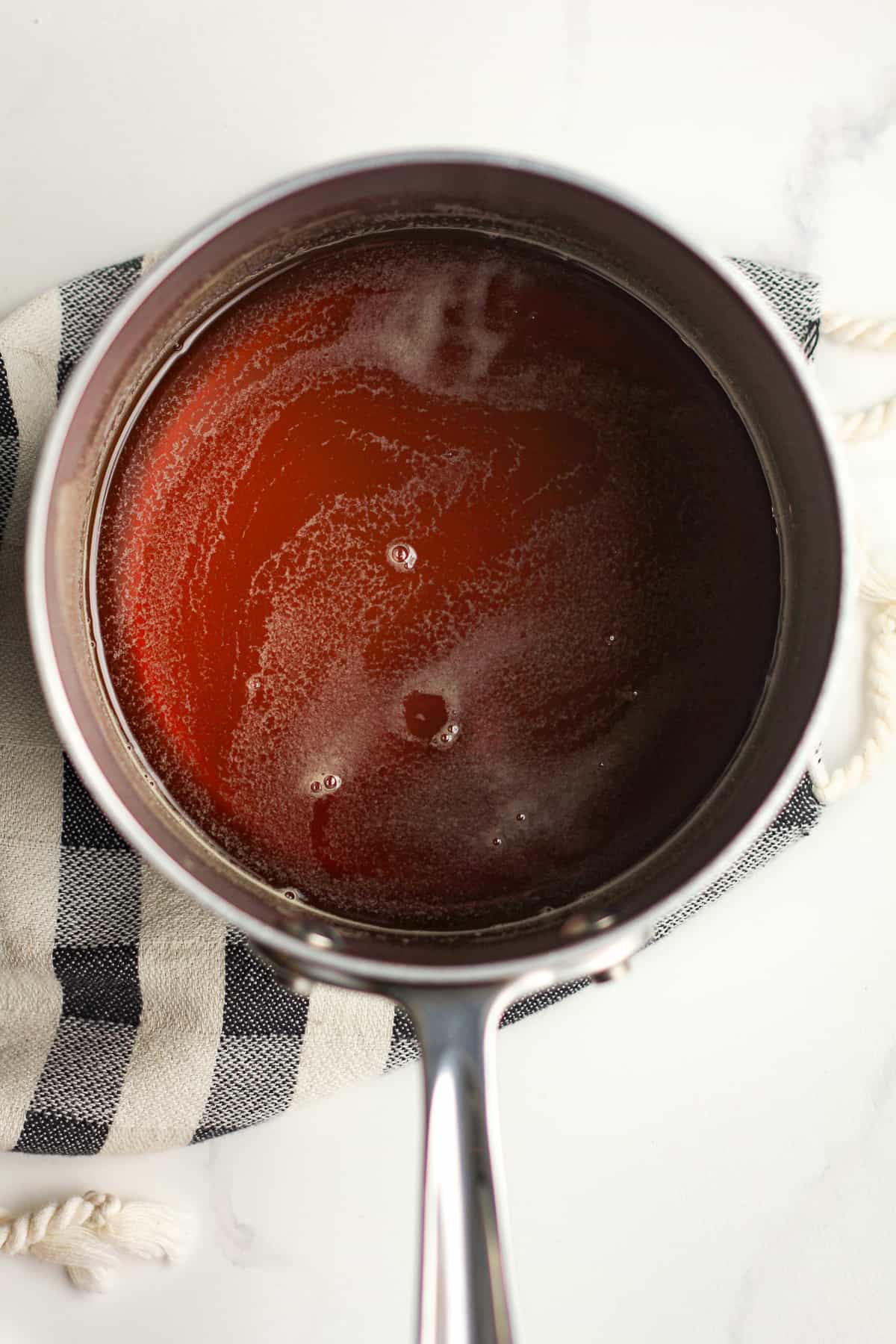 A pan of honey simple syrup after cooking.