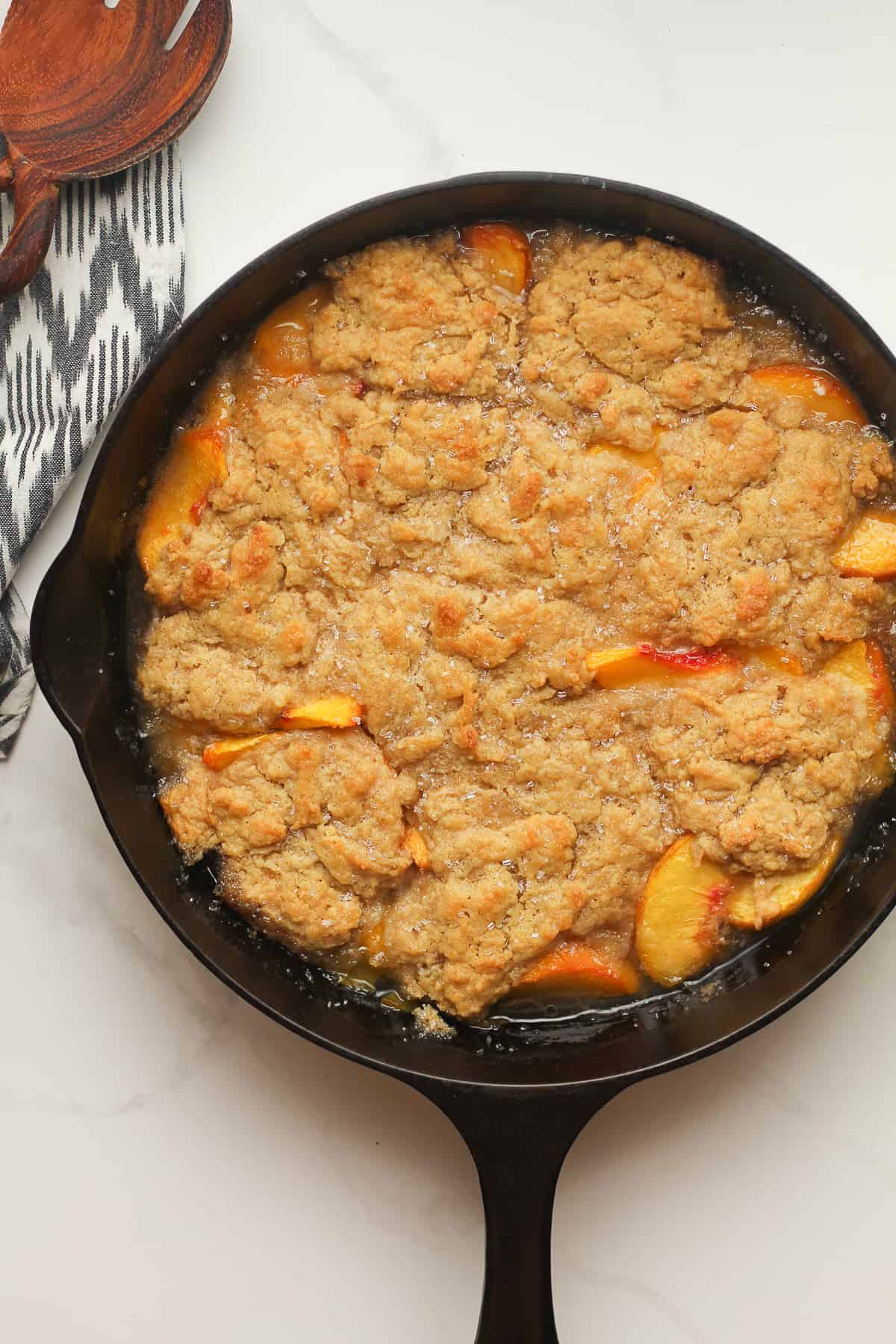 A skillet of peach cobbler just baked.