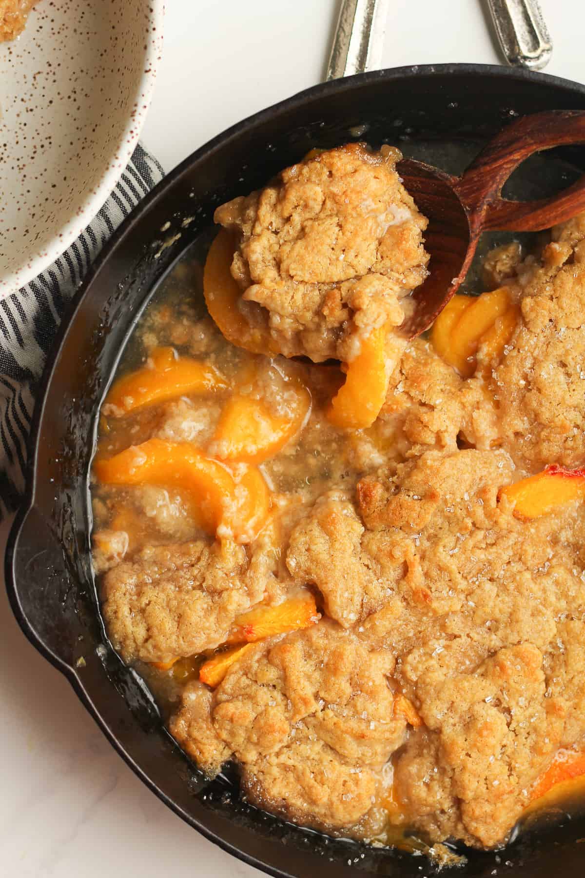 Closeup of a skillet of peach cobbler.