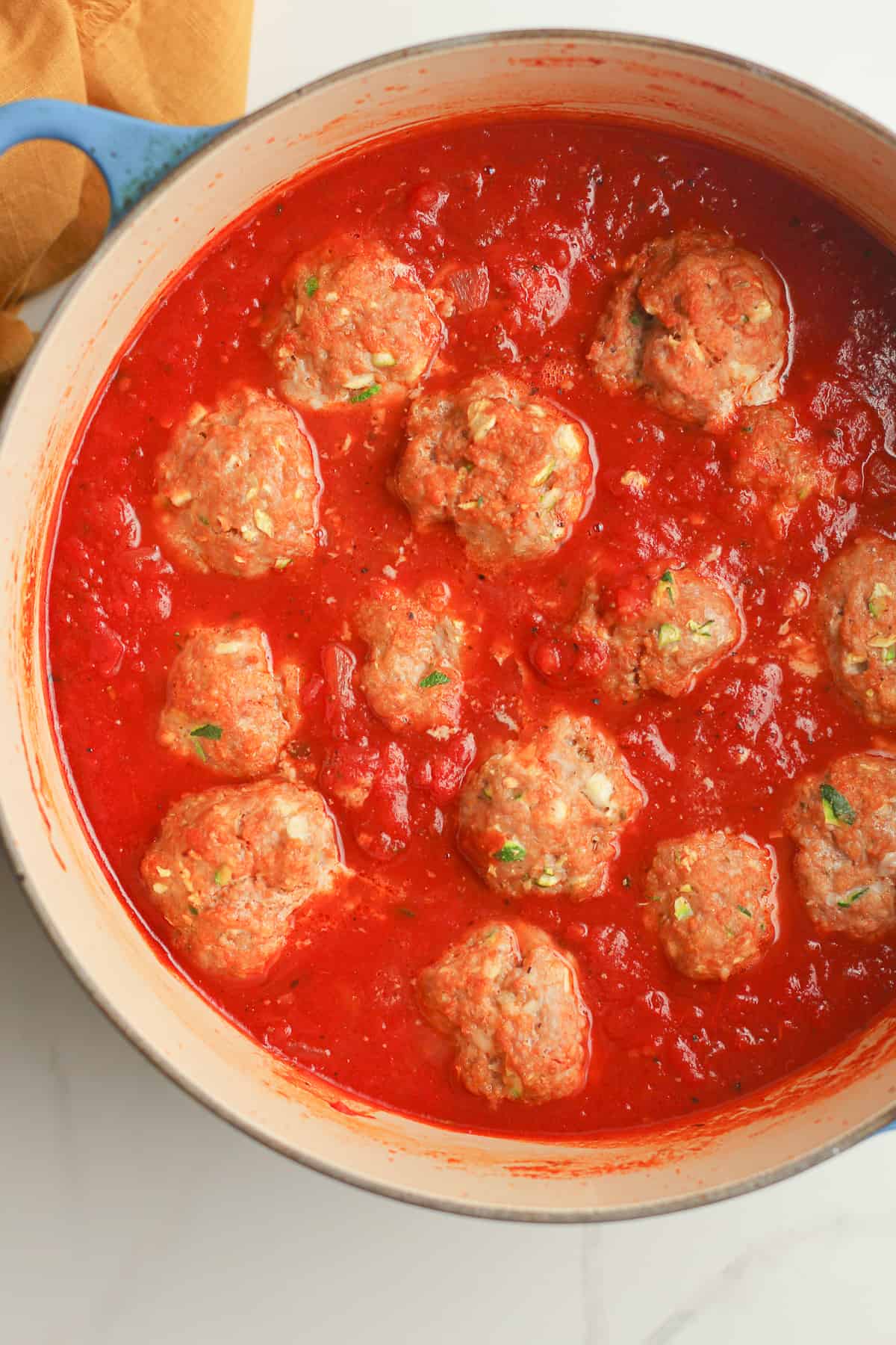 A stockpot of meatballs with sauce.