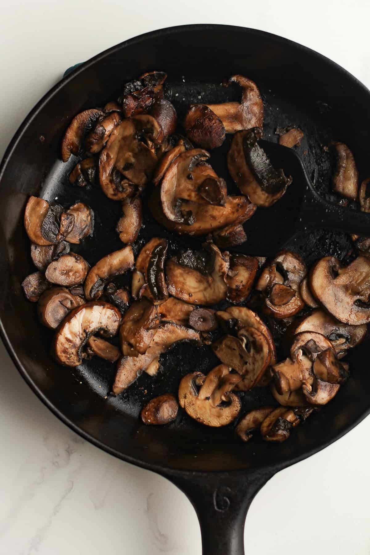 A skillet of browned mushrooms.