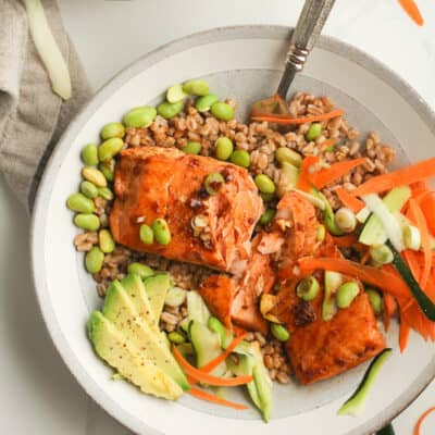 Overhead shot of a bowl with salmon and grains.