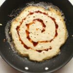 A pan with a cinnamon swirl pancake.